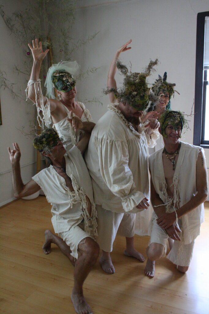 performer in tree masks
