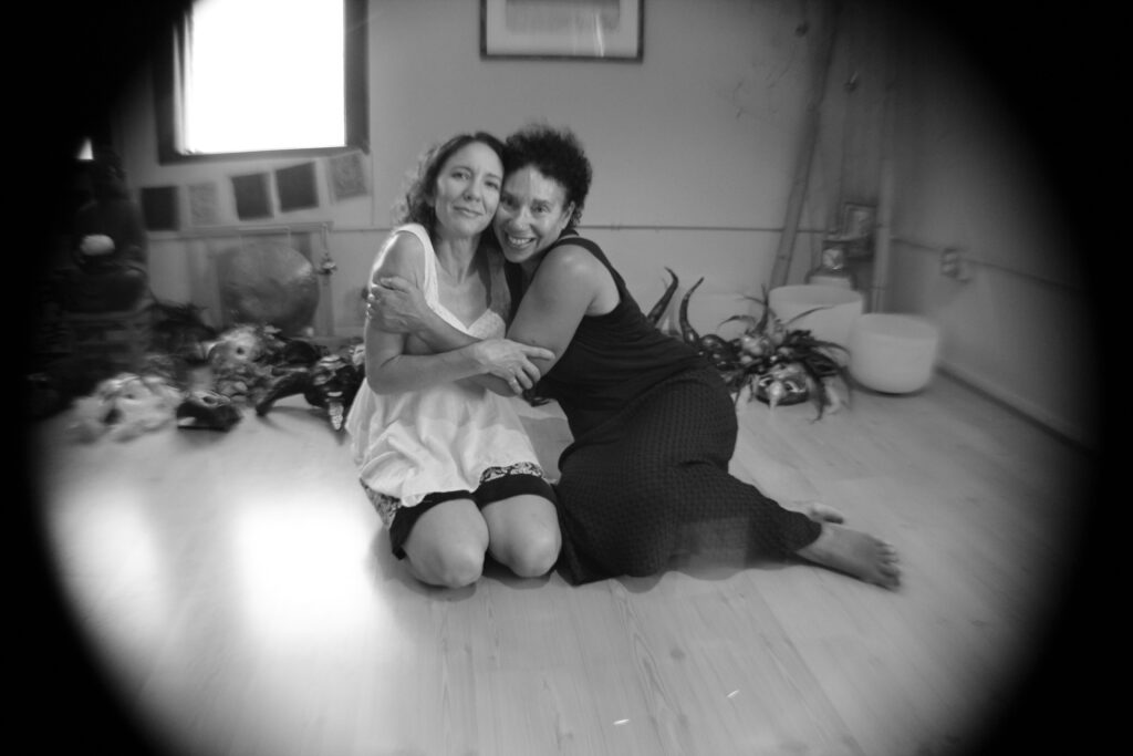Two women embrace